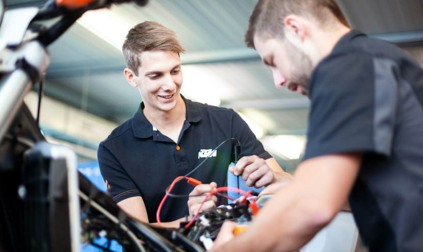 Apprentice working with his trainer 